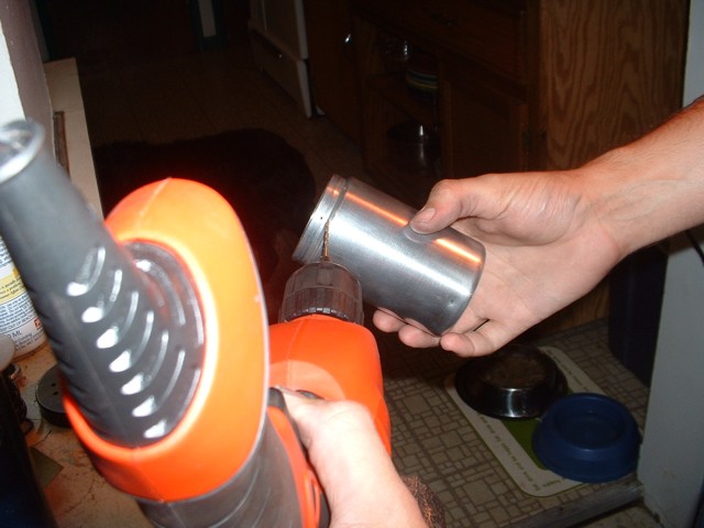 Drilling small holes in the top of the shaker's rim.