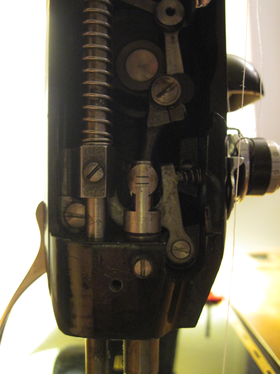A closeup of the needle bar mechanism.