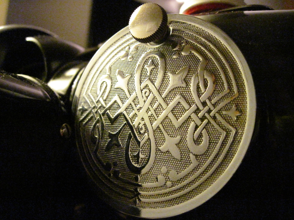 A closeup of the decorative access panel from the back of the machine.